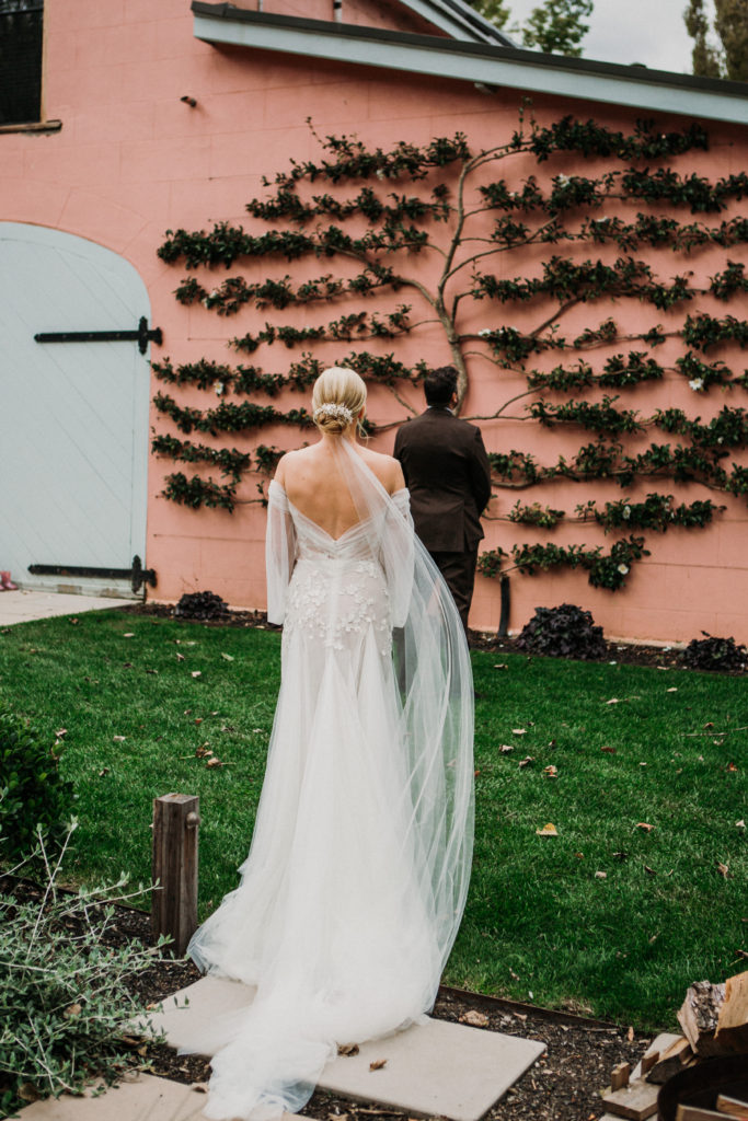 Groom about to take the first look of his bride in her wedding dress