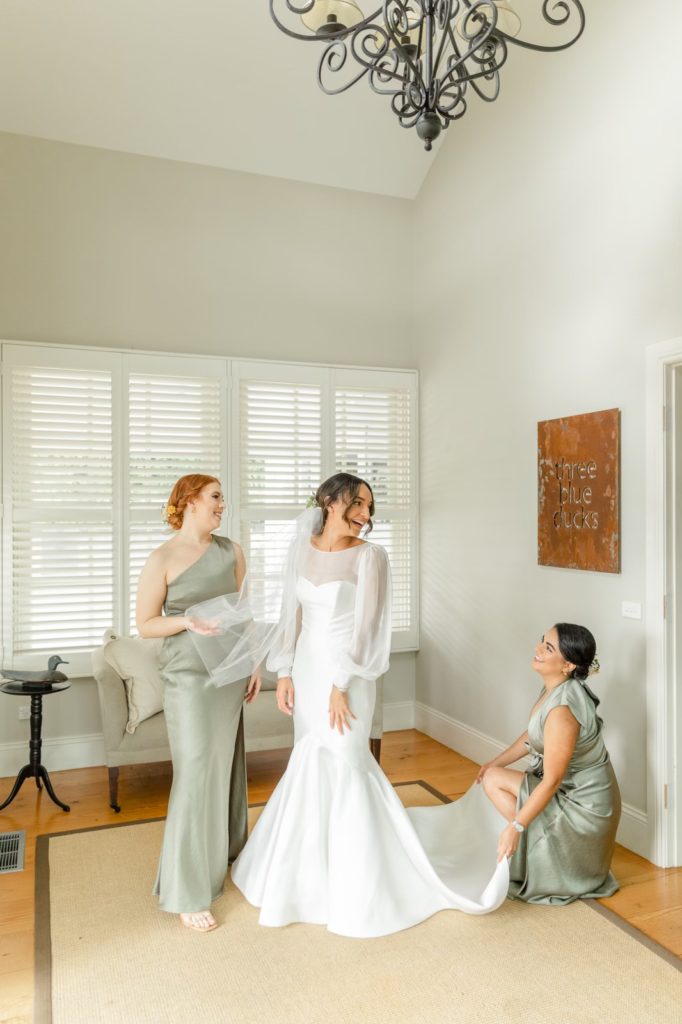 Bridesmaids with bride in weding dress with added sleeves