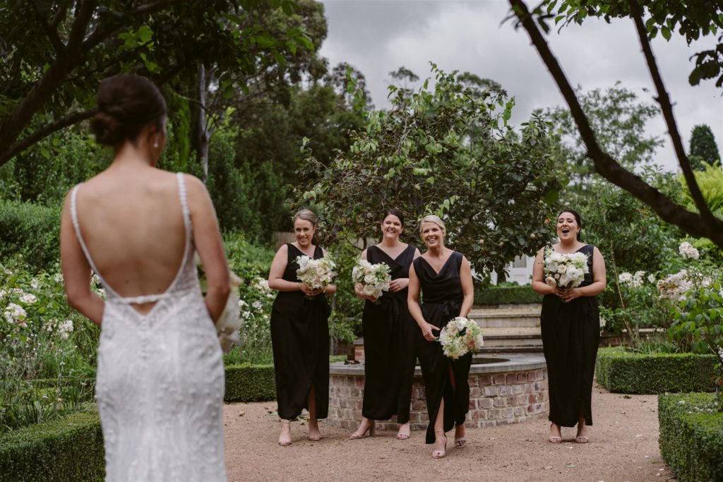 Back of wedding dress with bridesmaids