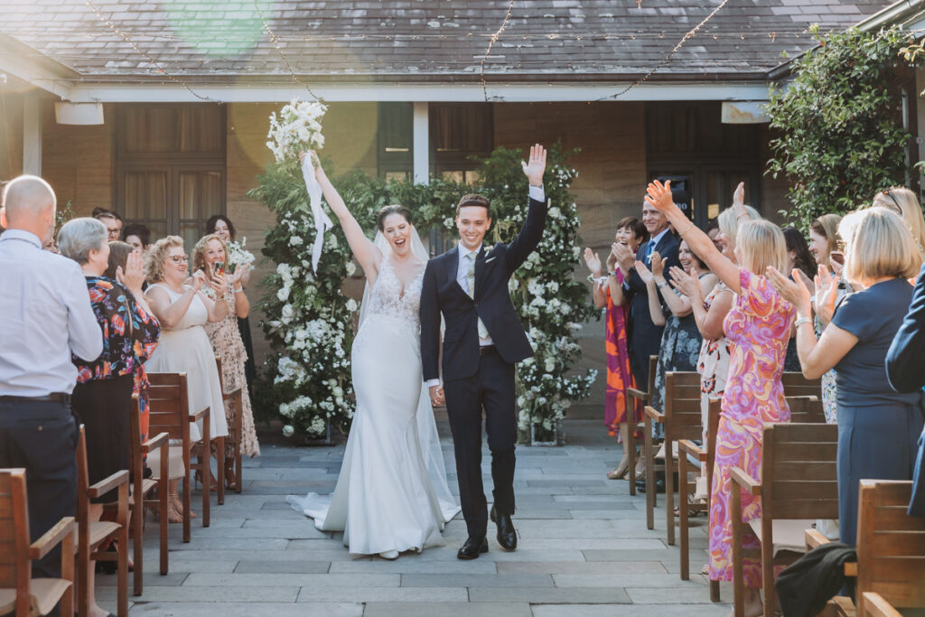 Bridal couple after wedding ceremony walking down the aisle