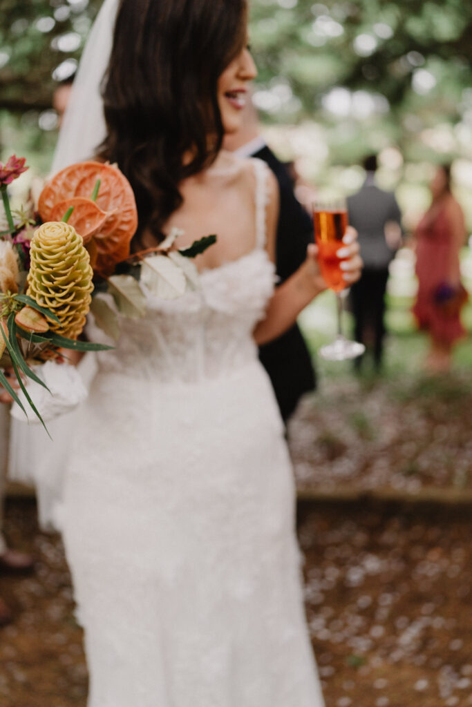 Blurry photo of bride in wedding dress with wine glass in her hand