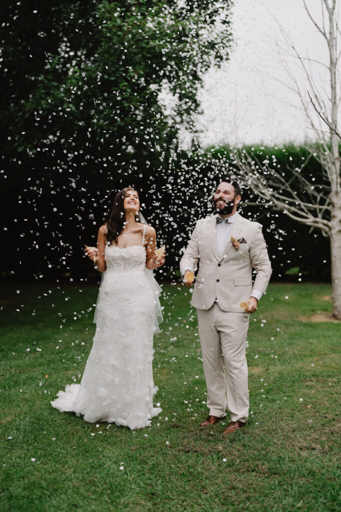 Wedding couple throwing confetti